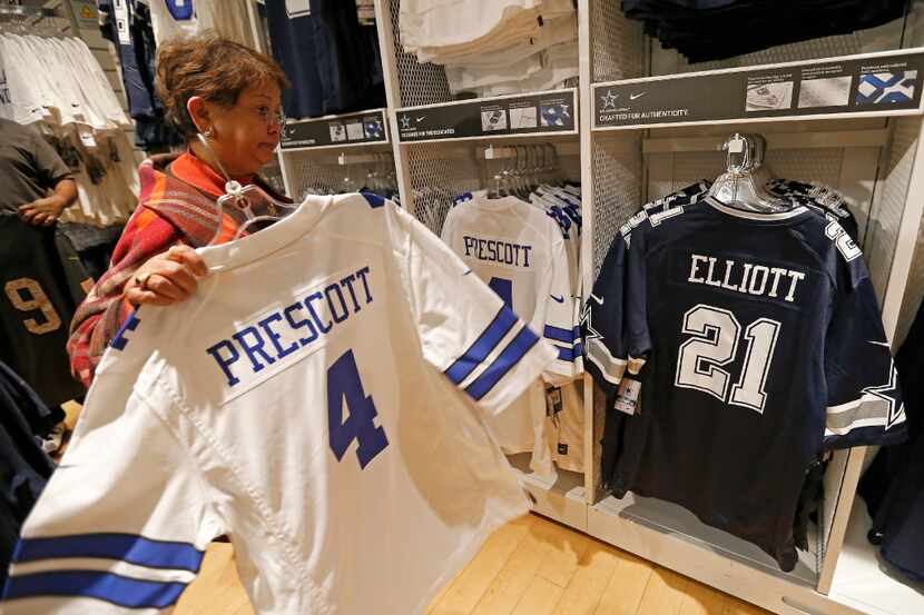 Customer Teresita Potts shops for a jersey of Dallas Cowboys quarterback Dak Prescott at the...