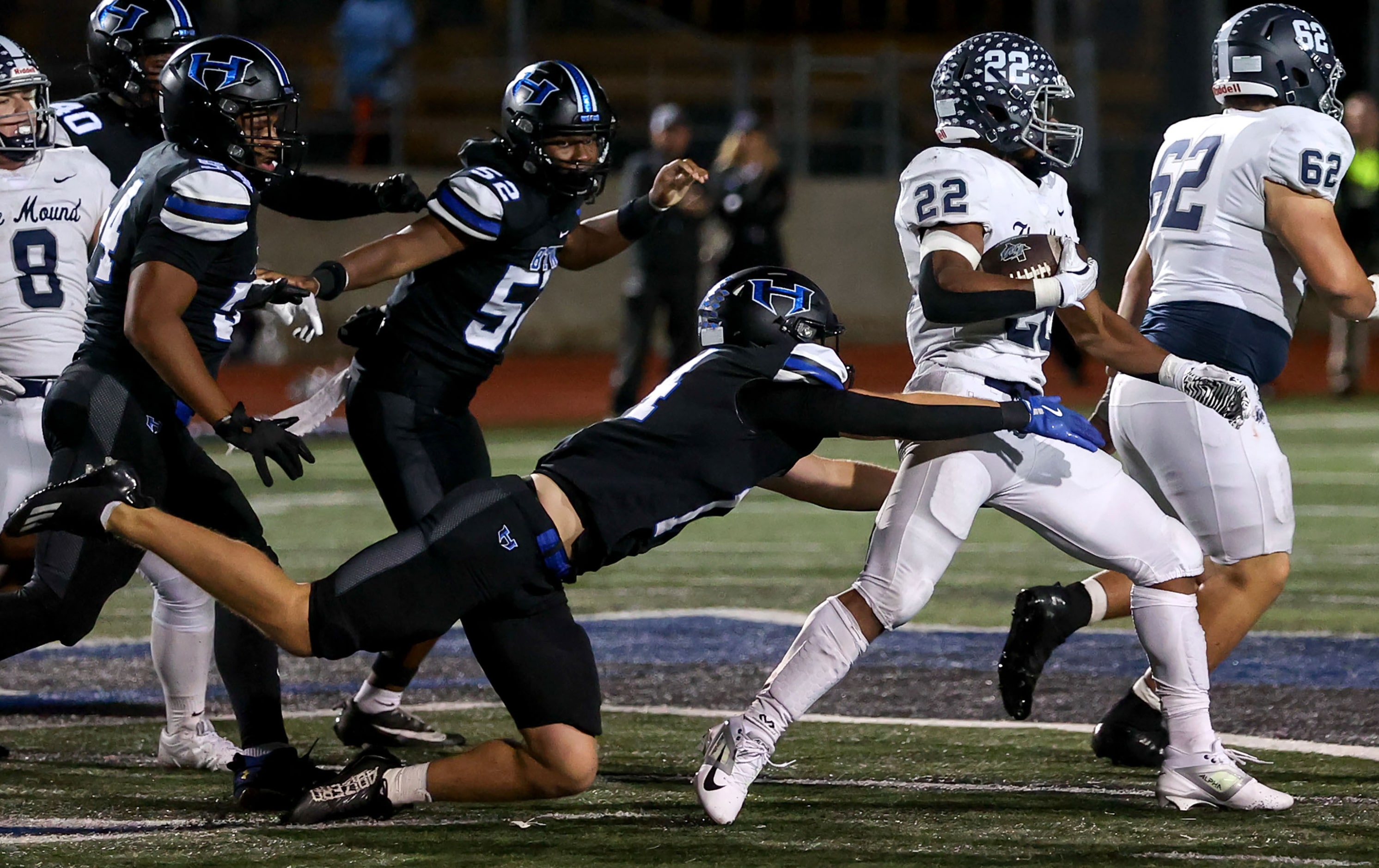 Flower Mound running back Marcus Simpson (22) tries to get past Hebron linebacker Luke Sharp...