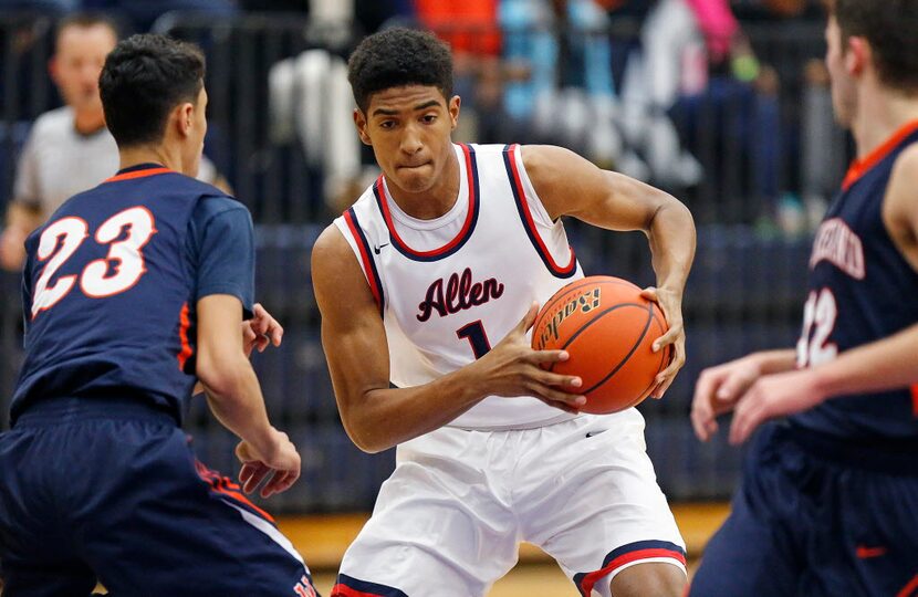 Allen forward Cam Christon (1) looks for a path to the basket as Wakeland gaurd javante...