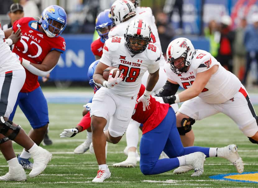 Texas Tech running back Tahj Brooks (28) rushes for a first down during the first half of an...