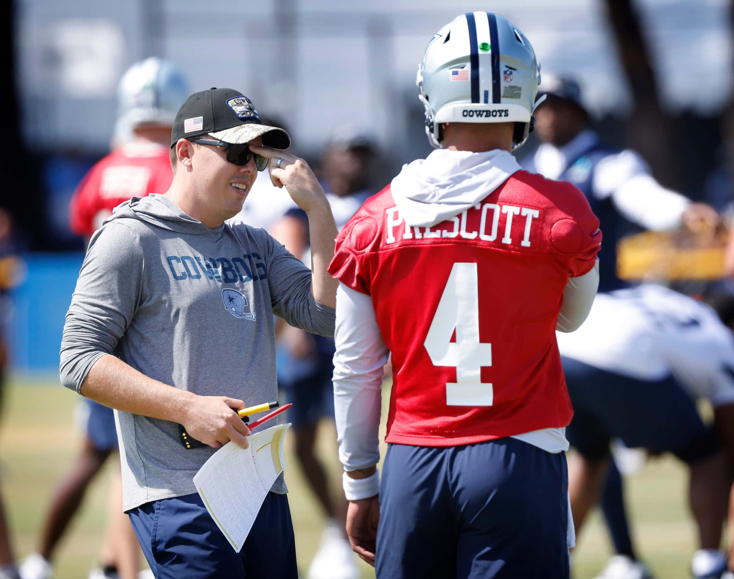Dallas Cowboys quarterback Dak Prescott (4) and offensive coordinator Kellen Moore compares...