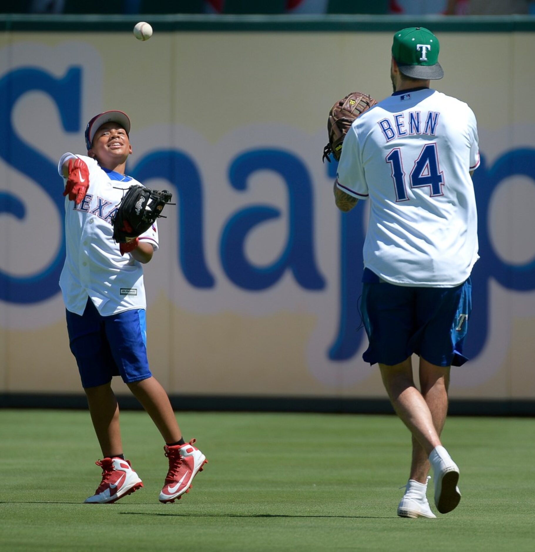 Dallas Stars team captain Jamie Benn, right, plays catch with Texas Rangers Adrian Beltre's...