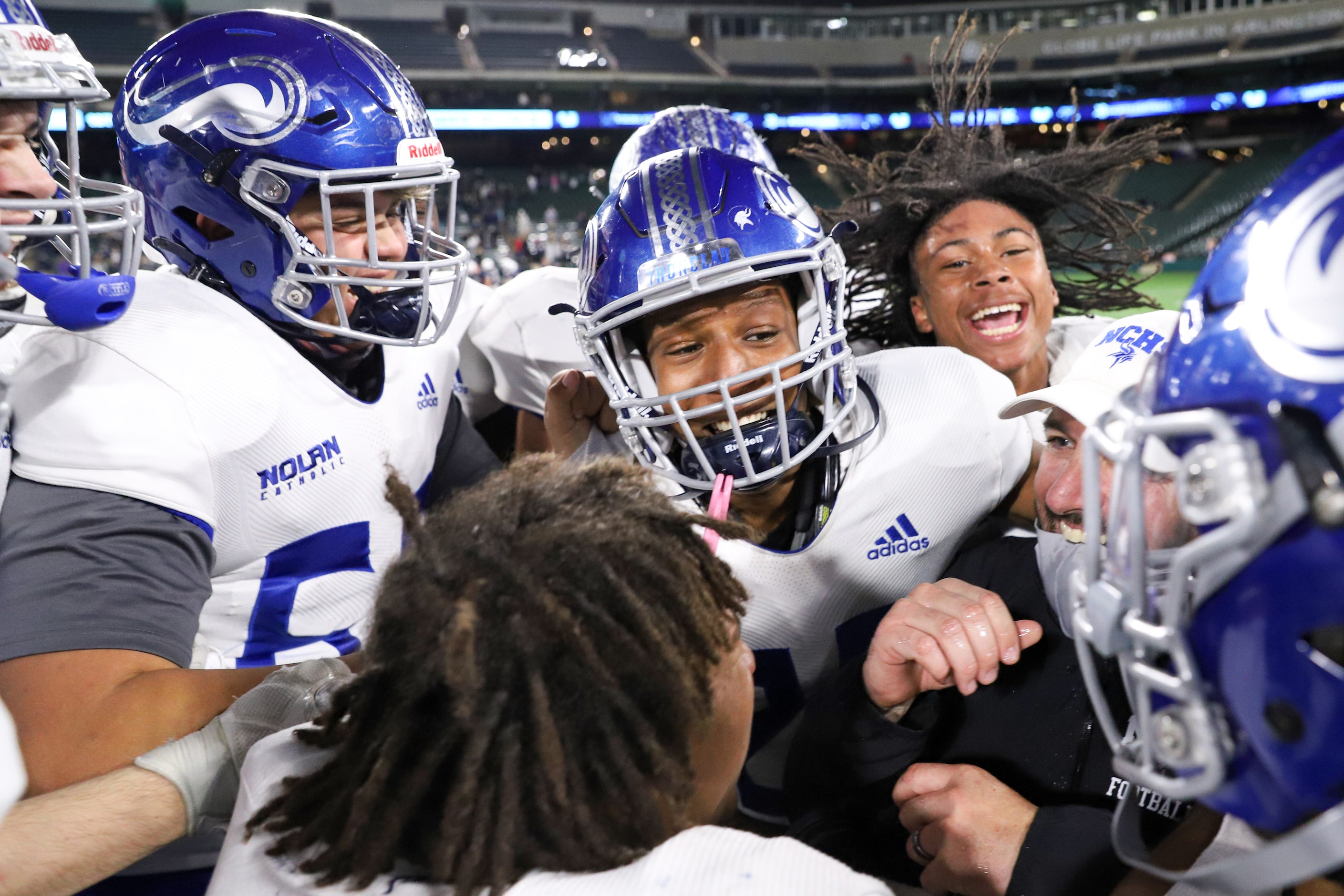 Fort Worth Nolan head coach David Beaudin celebrates with his team after a win over Fort...