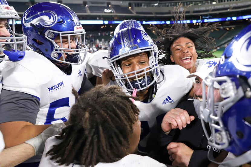 Fort Worth Nolan head coach David Beaudin celebrates with his team after a win over Fort...