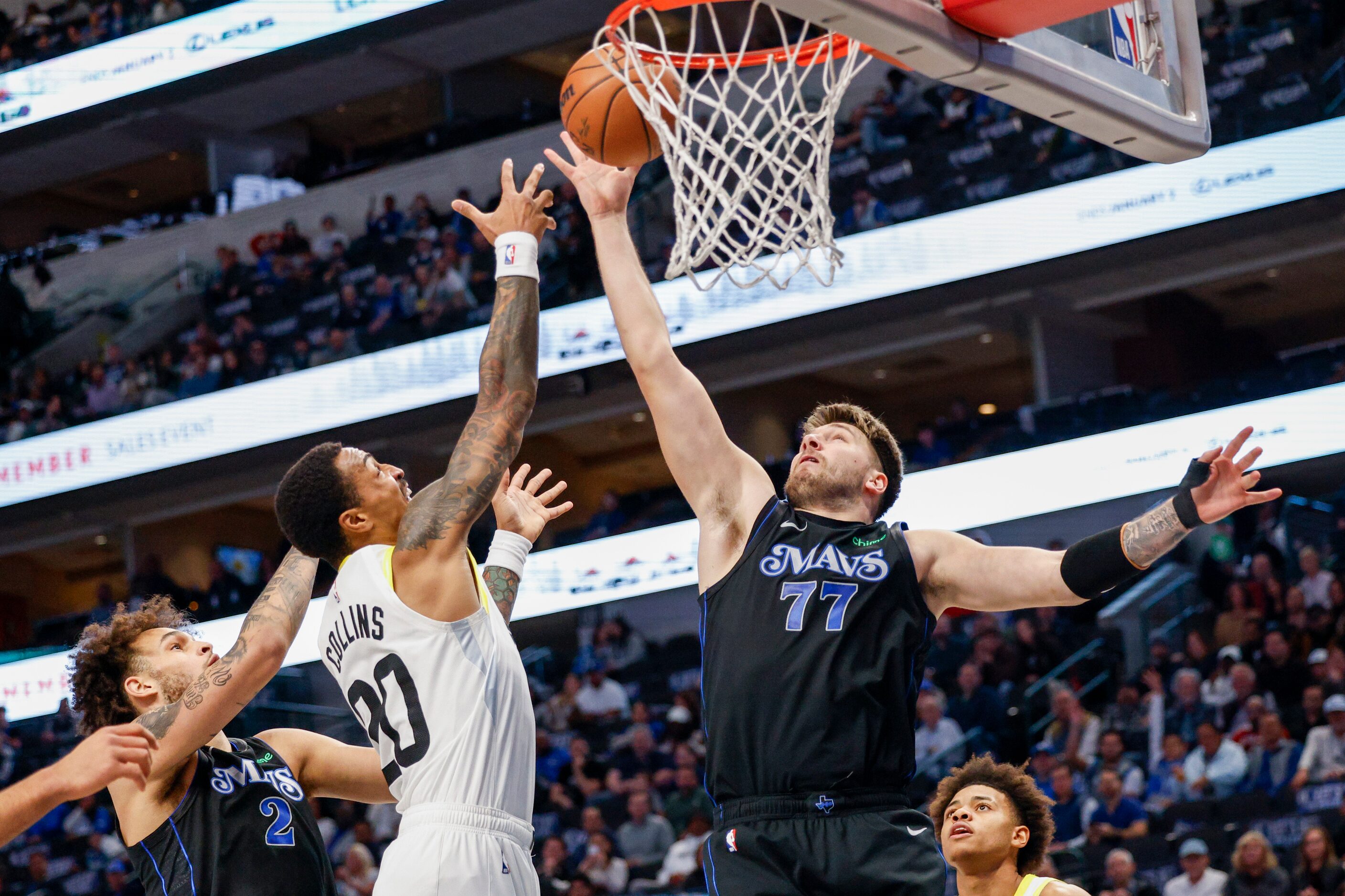 Dallas Mavericks guard Luka Doncic (77) collects a rebound and tips it in for a basket...