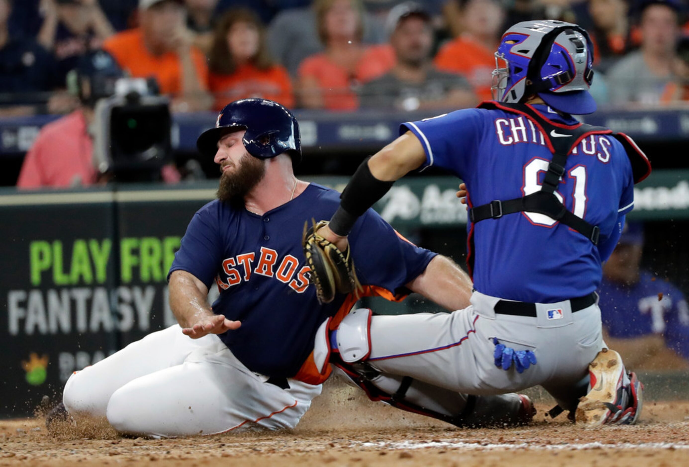 Houston Astros' Tyler White, left, is tagged out by Texas Rangers catcher Robinson Chirinos...