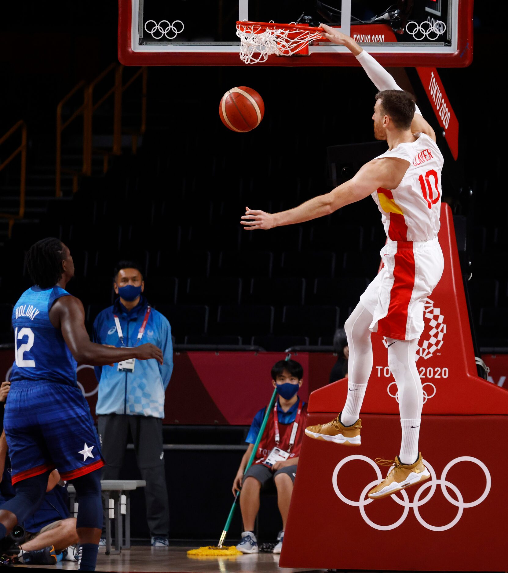 Spain’s Victor Claver (10) dunks the ball in front of USA’s Jrue Holiday (12) during the...