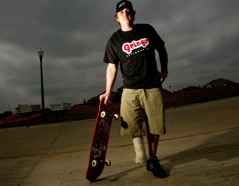 Jon Comer, who died in 2019, stands with his skateboard outside his home in Keller. The...