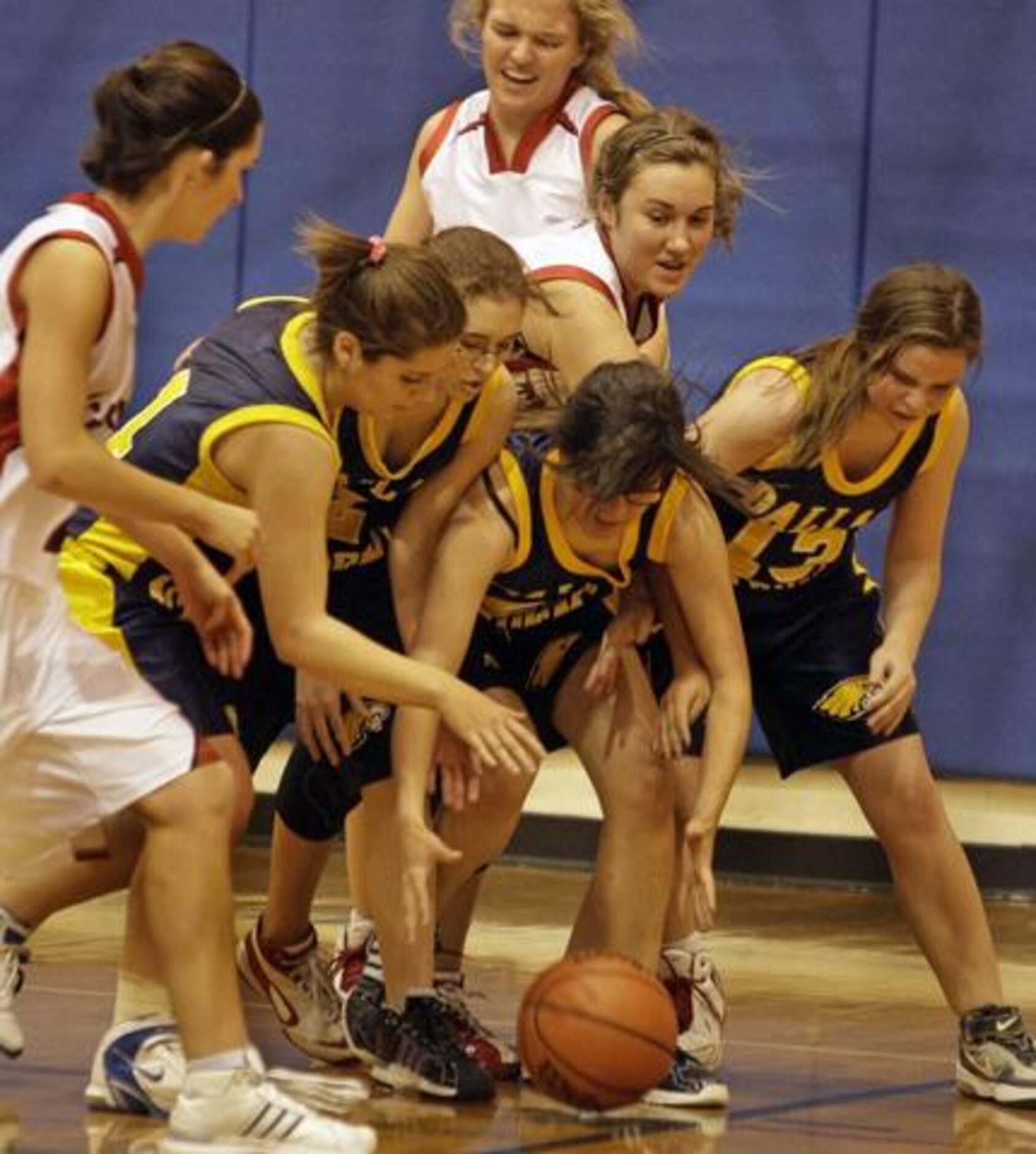 Dallas Academy (dark shirts) and Cambridge players scramble for a loose ball during...