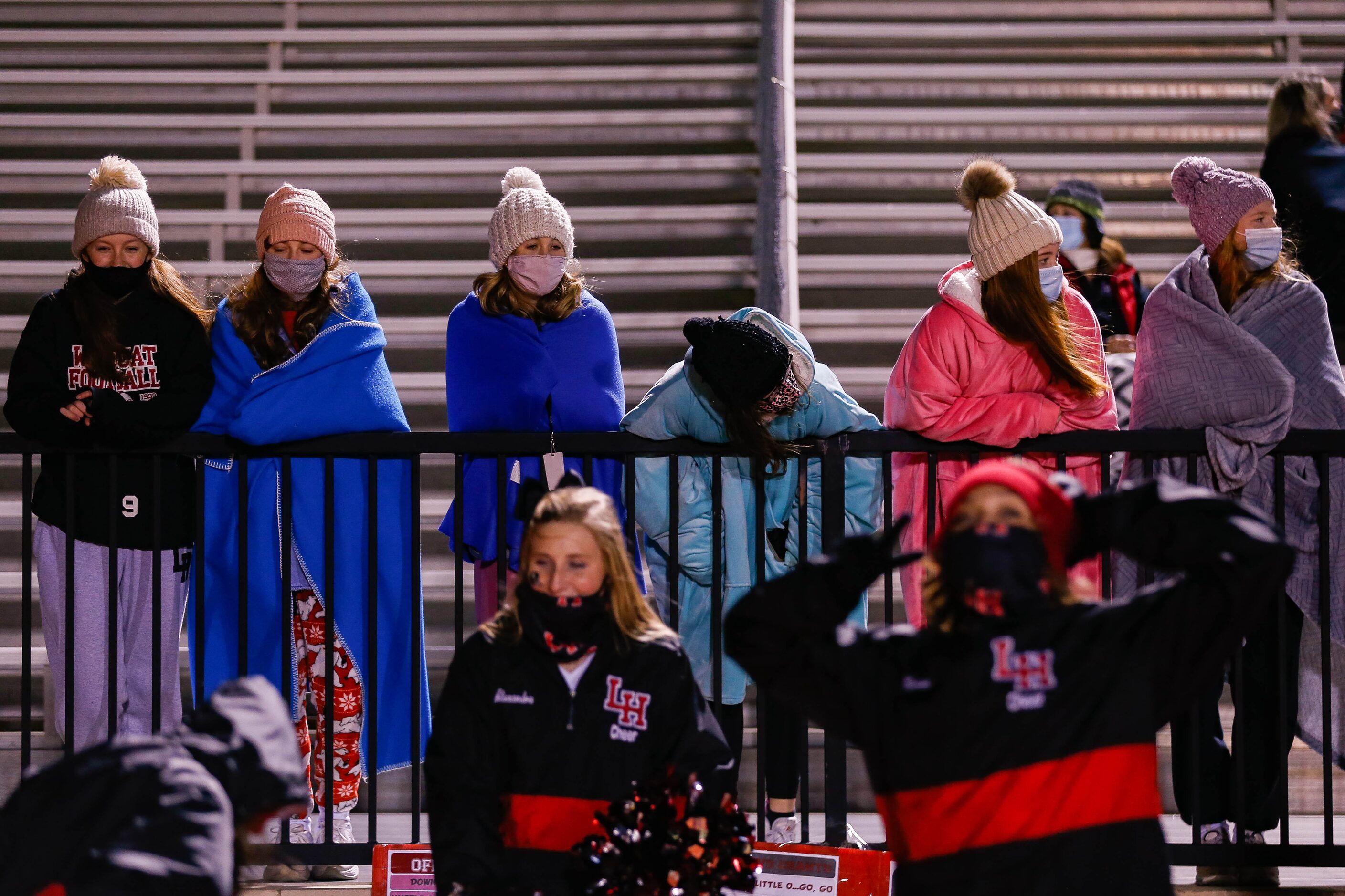 Lake Highlands' fans bundle up as they watch during a the second quarter of a high school...