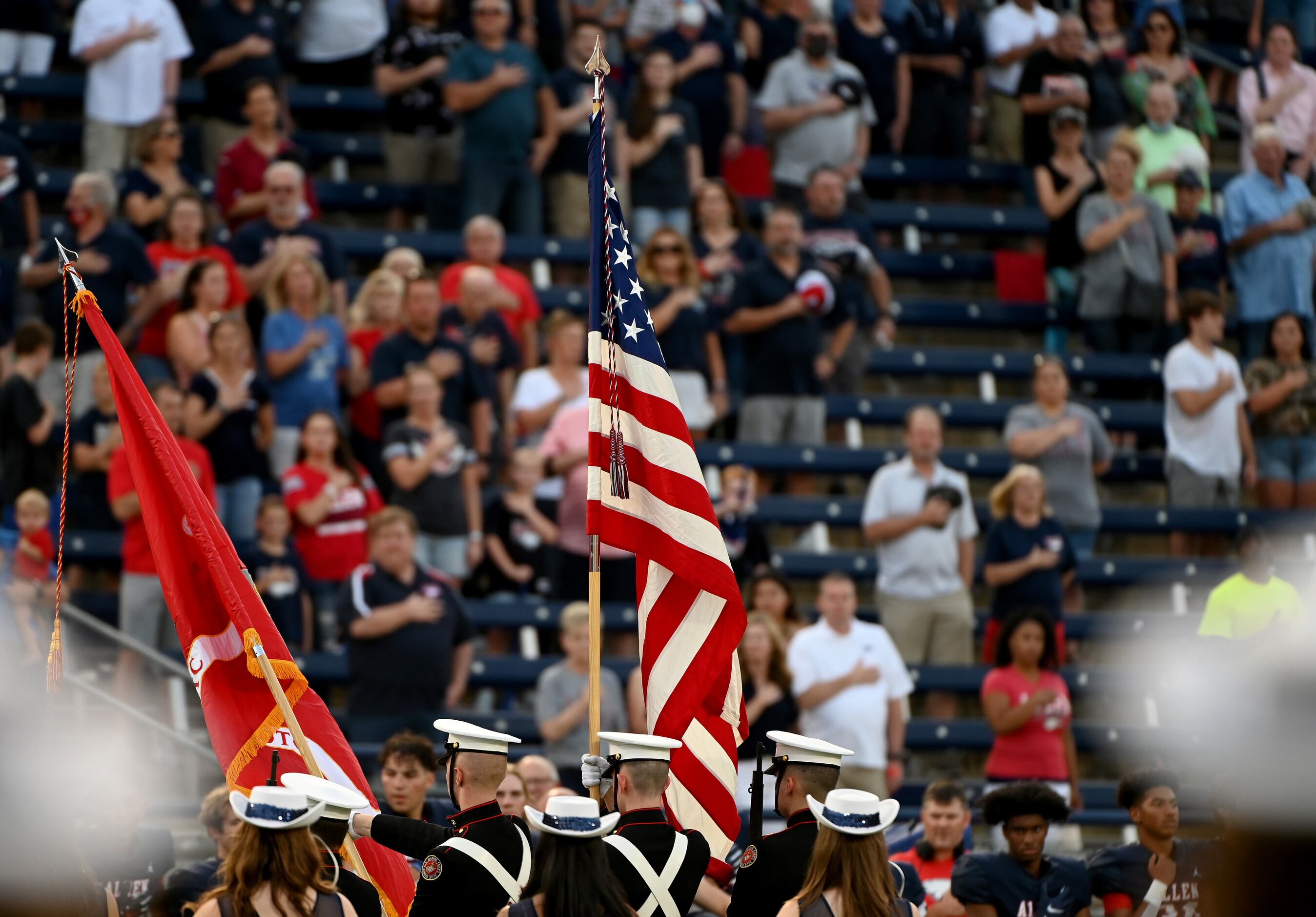 The Allen Marine Jr. ROTC present the colors before a high school football game between...