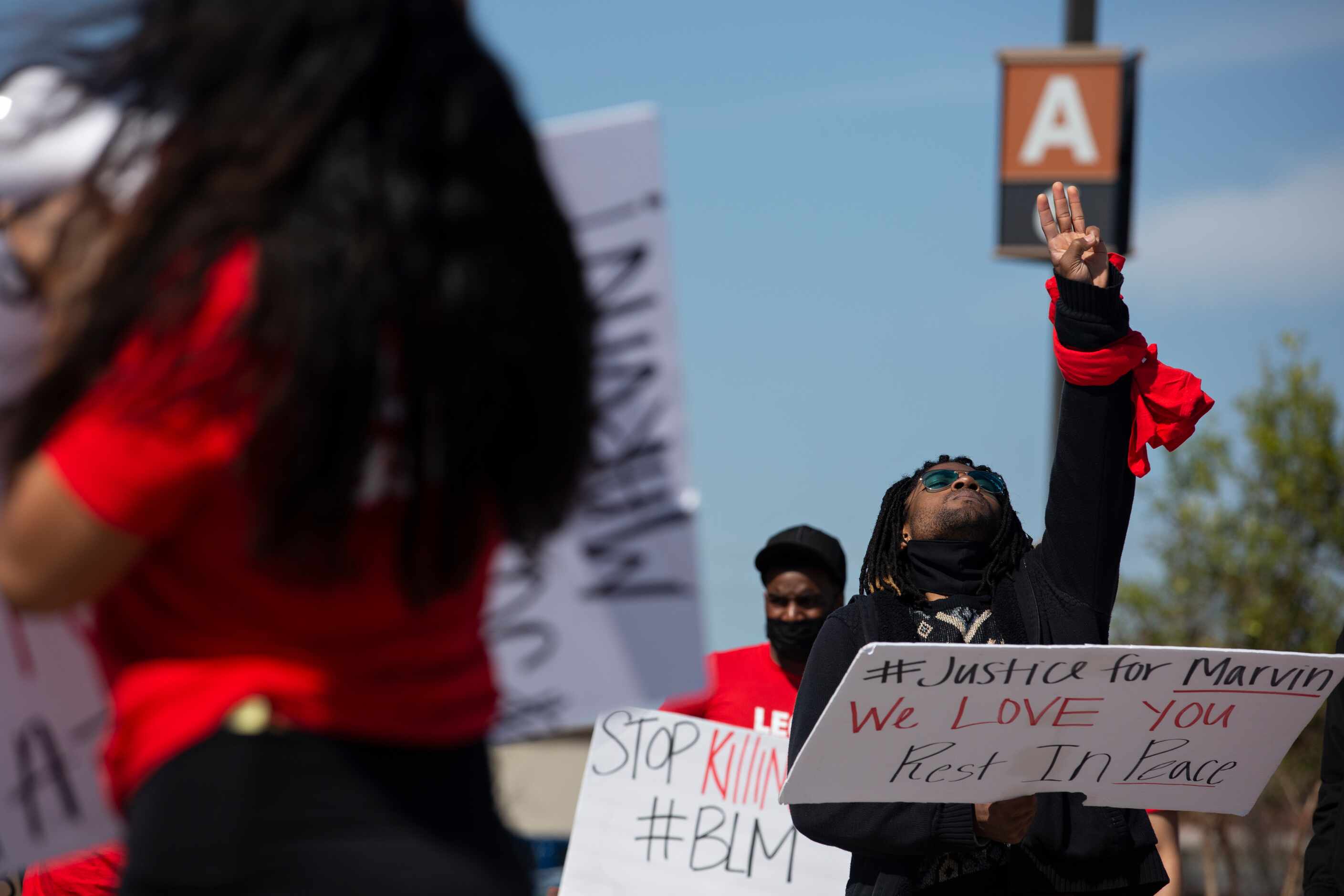 Quinten Scott holds up three fingers during a march through the Allen Outlets on Sunday,...