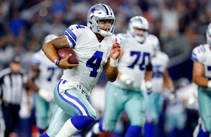Dallas Cowboys quarterback Dak Prescott (4) takes off running after not finding an open...