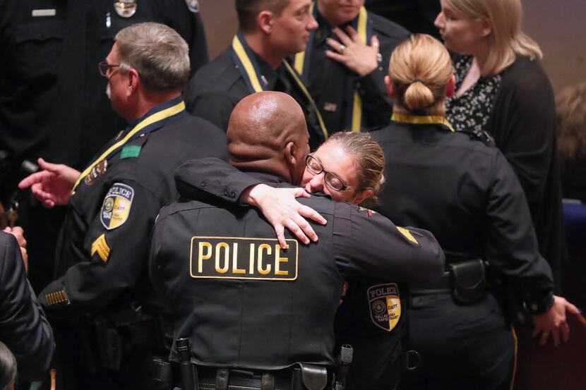 DART officer Misty McBride hugged a fellow officer before a July 12 memorial service...