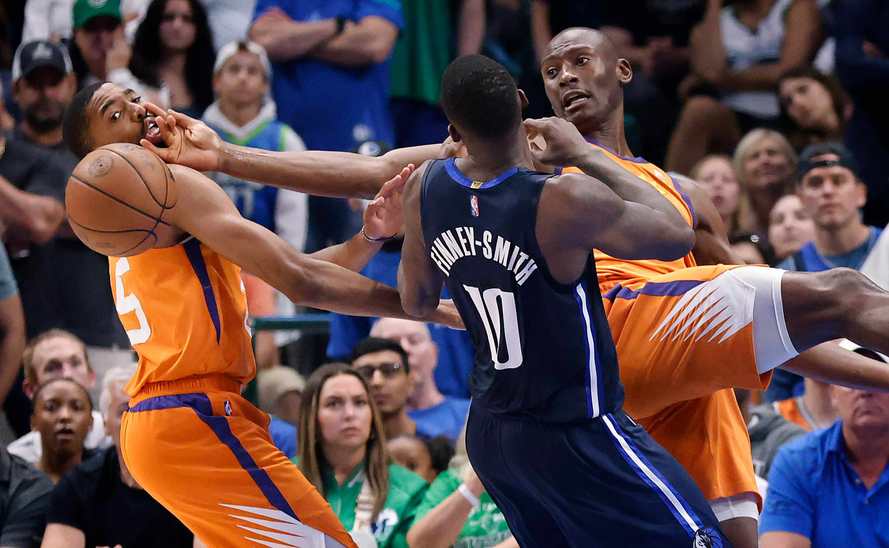 Phoenix Suns center Bismack Biyombo (right) and hits teammate Cameron Payne (left) in the...