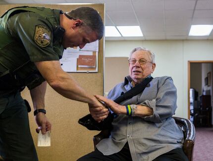 K9 Patrol Officer Lance Montee (left) shakes hands with Calvin Brundrett after the Grand...
