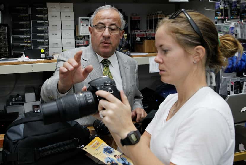 Competitive Camera owner Ramsey Jabbour, left, helps Chelsie Paine of Plano with a camera on...