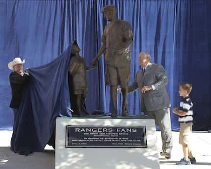 Artist Bruce Greene, Texas Rangers President Nolan Ryan and Cooper Stone take part in...