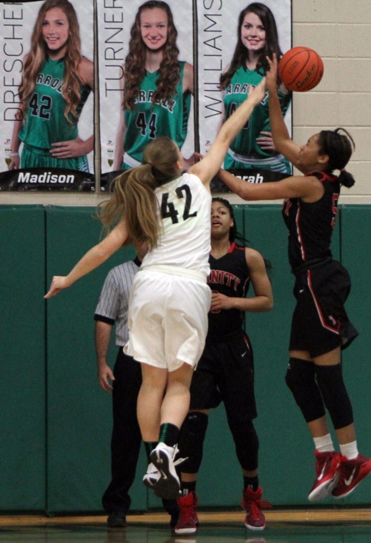 Southlake Carroll post Madison Drescher (42) leaps to block a shot from Euless Trinity guard...