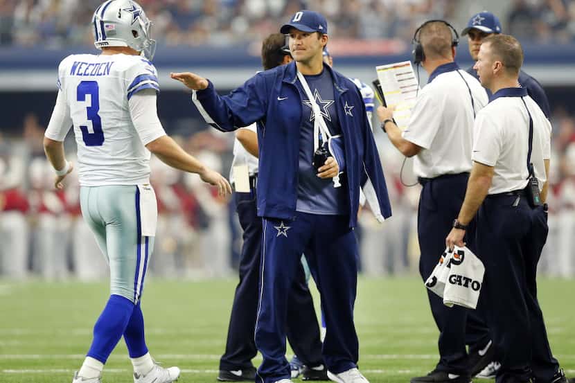 Dallas Cowboys quarterback Tony Romo (center) greets starting quarterback Brandon Weeden (3)...