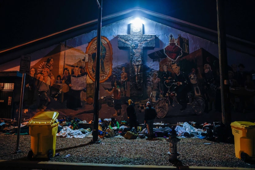 Migrants spend the night on the street at the Centro Pastoral Sagrado Corazon in El Paso on...