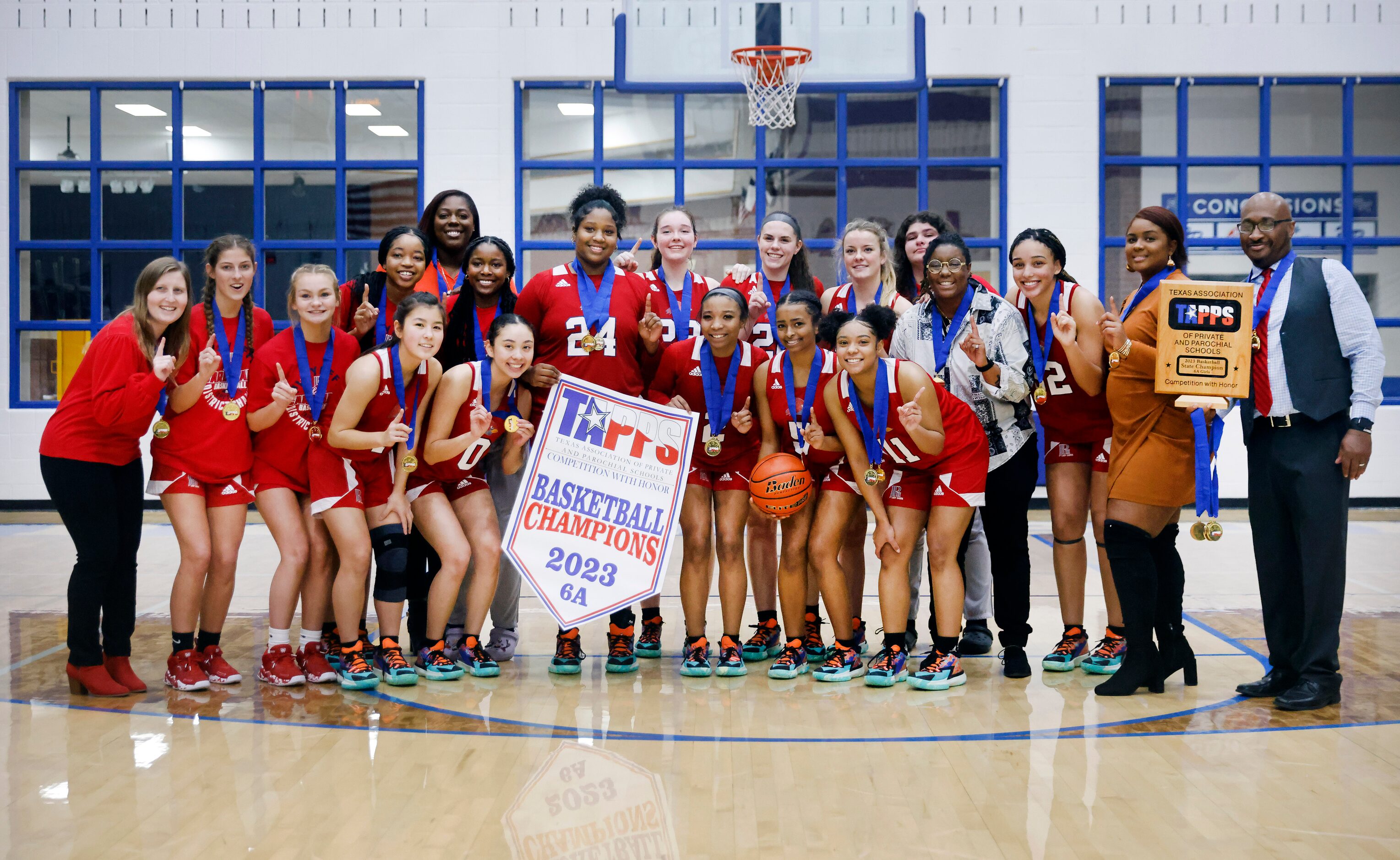 The John Paul II girls basketball team, with head coach John Griffin (right), pose with the...