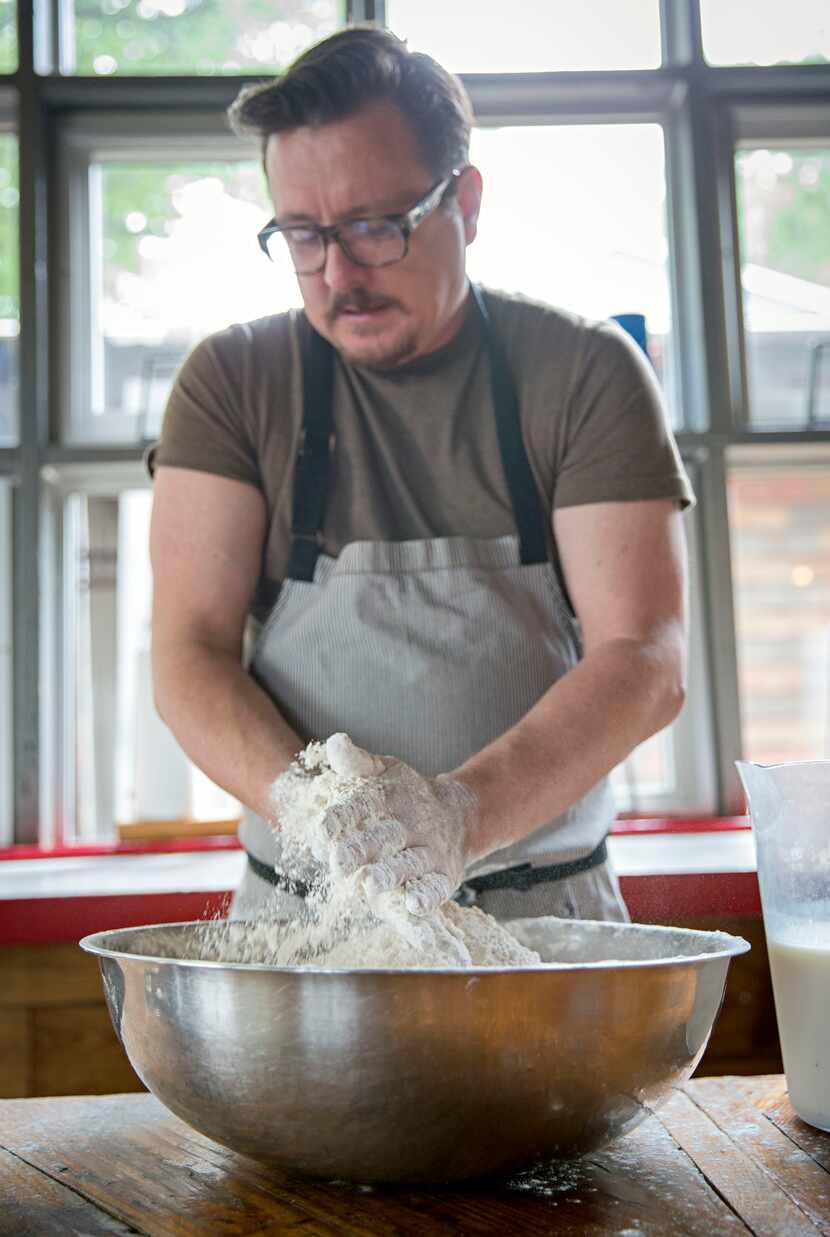 Chef Tim Byres mixes lard with dry ingredients as he prepares buttermilk biscuits at Chicken...
