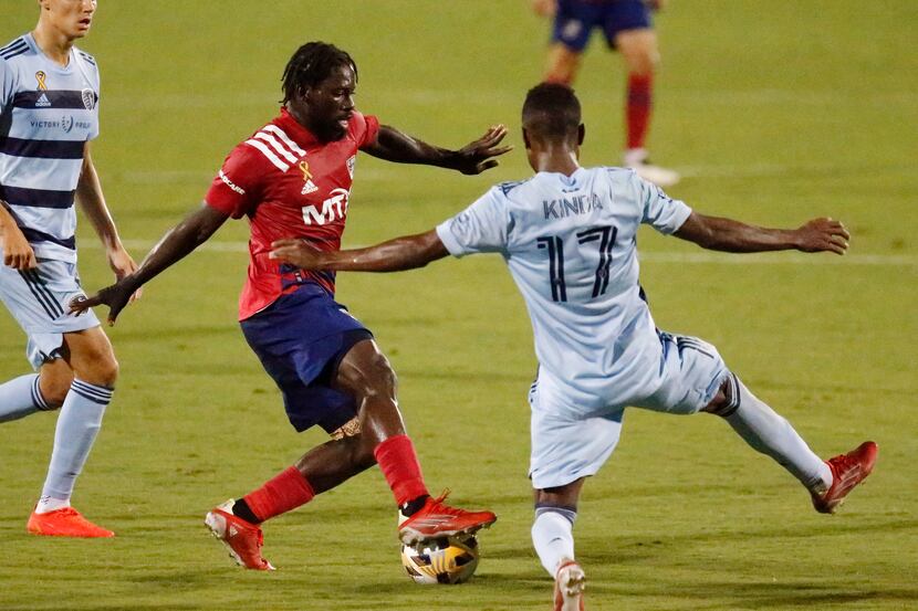 FC Dallas midfielder Ema Twumasi (22) looks to pass as Sporting Kansas City midfielder Gadi...