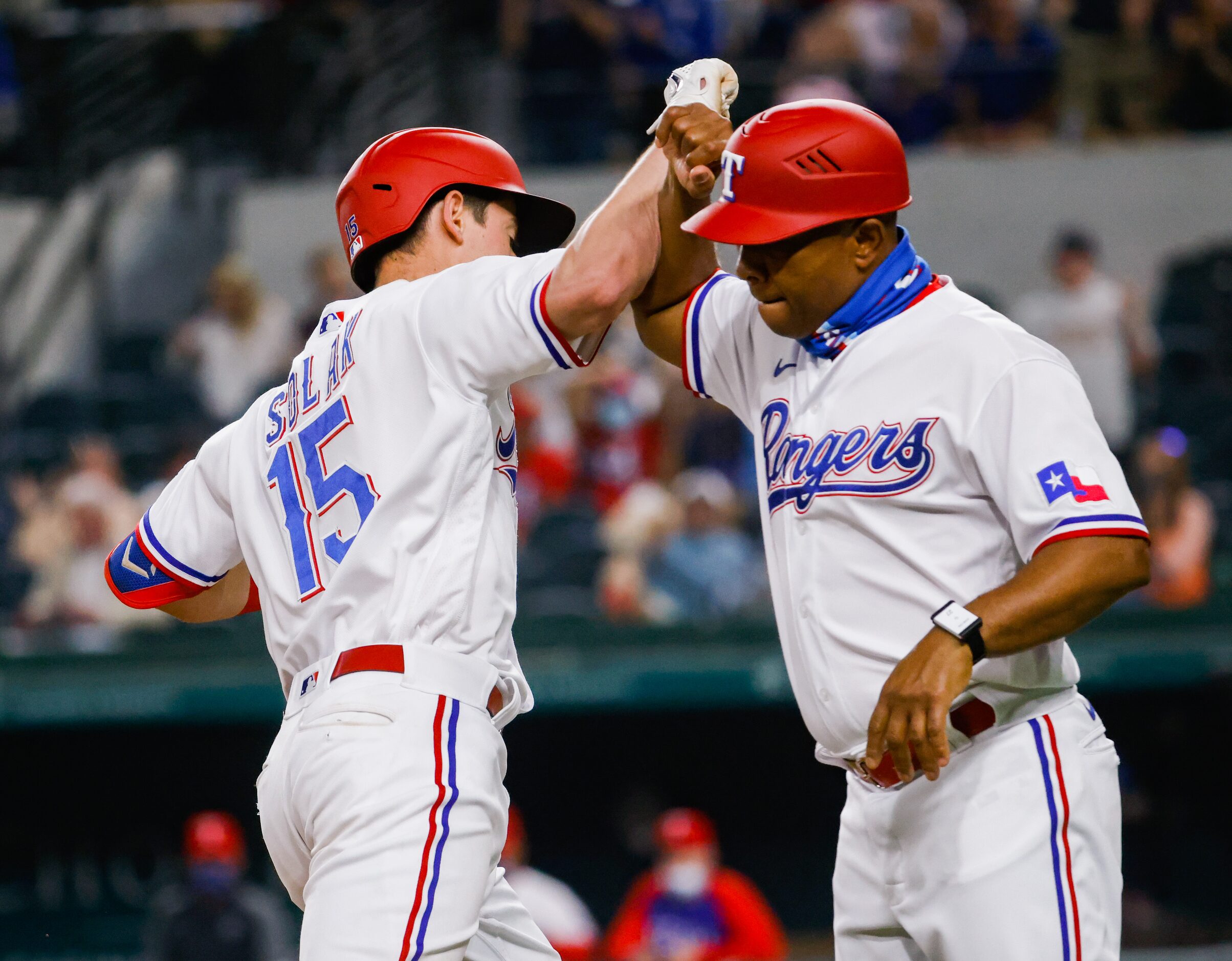 Texas Rangers second baseman Nick Solak (15) elbows Texas Rangers third base coach Tony...