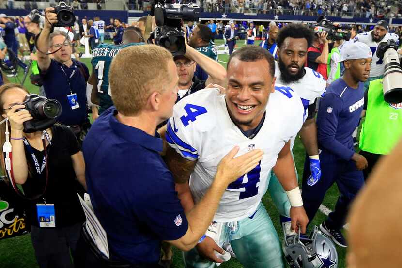 Dallas Cowboys head coach Jason Garrett and quarterback Dak Prescott (4) celebrate their...