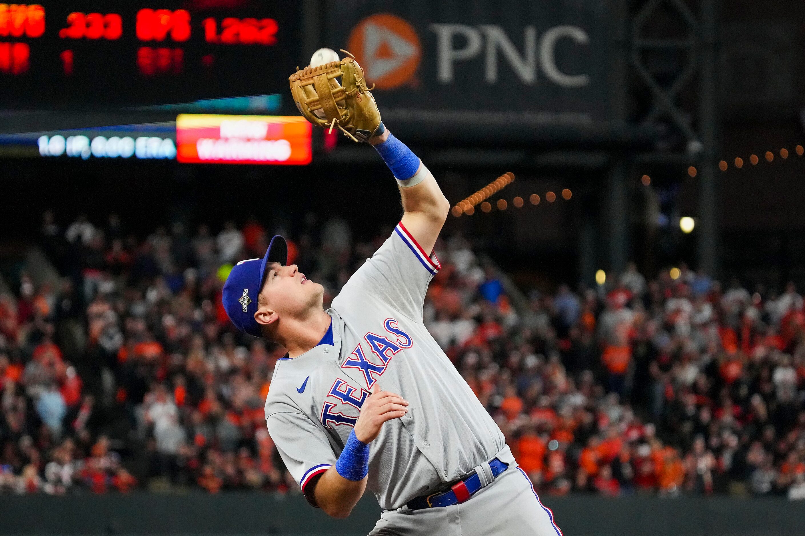 Texas Rangers third baseman Josh Jung makes the play on a popup by Baltimore Orioles...