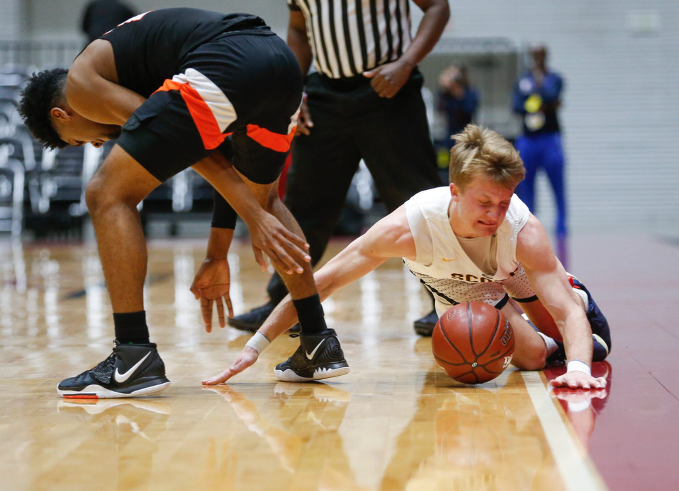 Highland Park's Drew Scott (5) slides out of bounds while grappling with Lancaster's Marco...