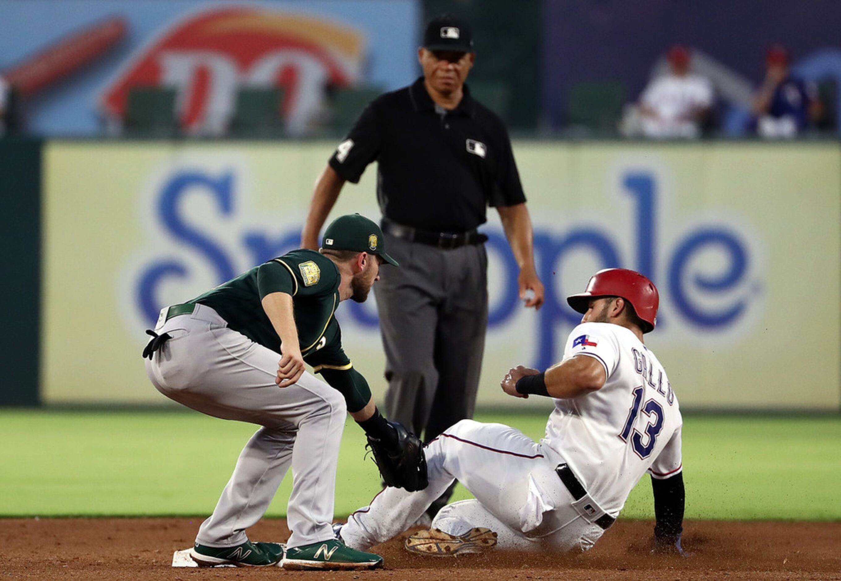 ARLINGTON, TX - JULY 25:  Joey Gallo #13 of the Texas Rangers is caught trying to steal...