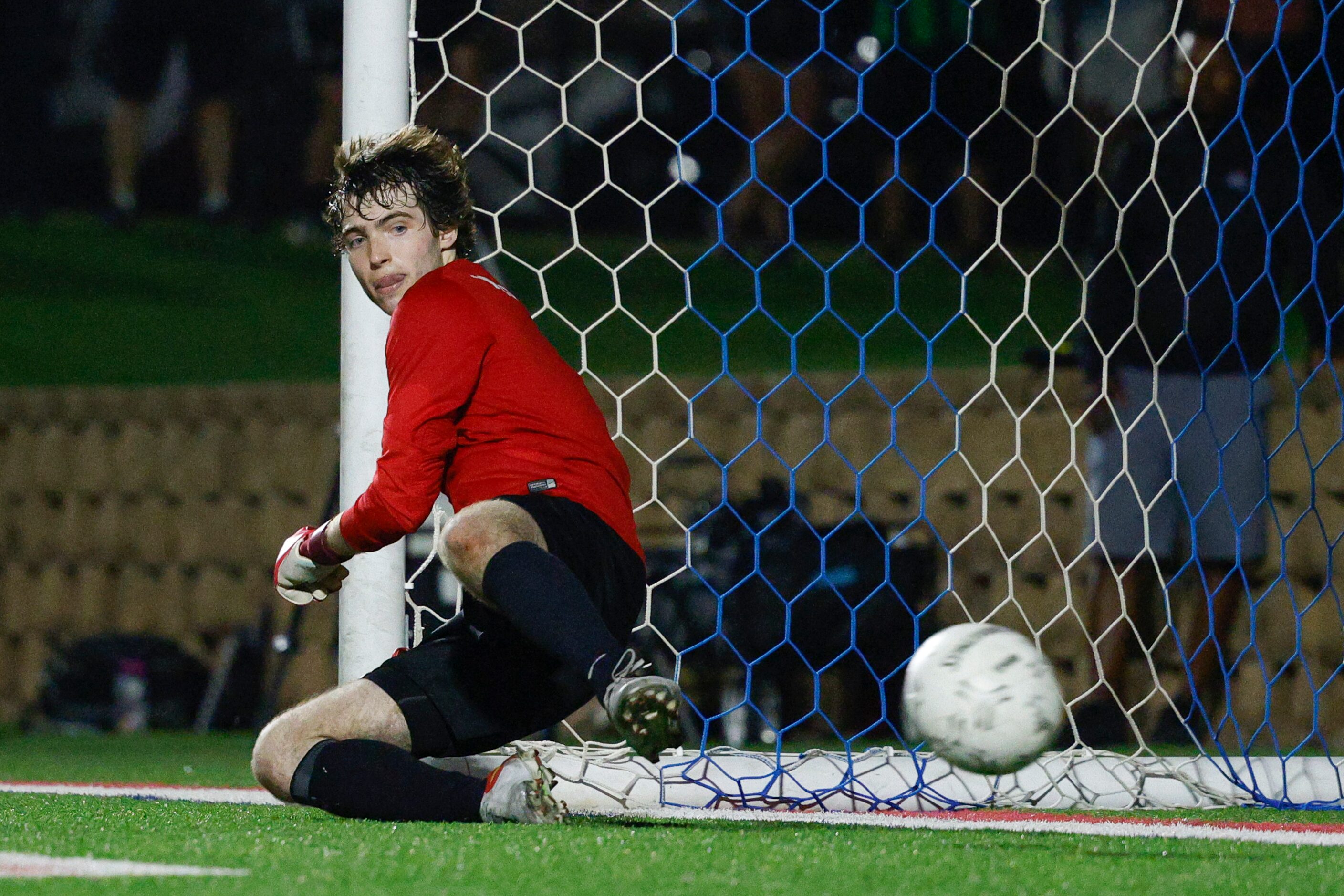 Plano goalkeeper Henry Huffstetler (1) watches a penalty kick cross the line during a...