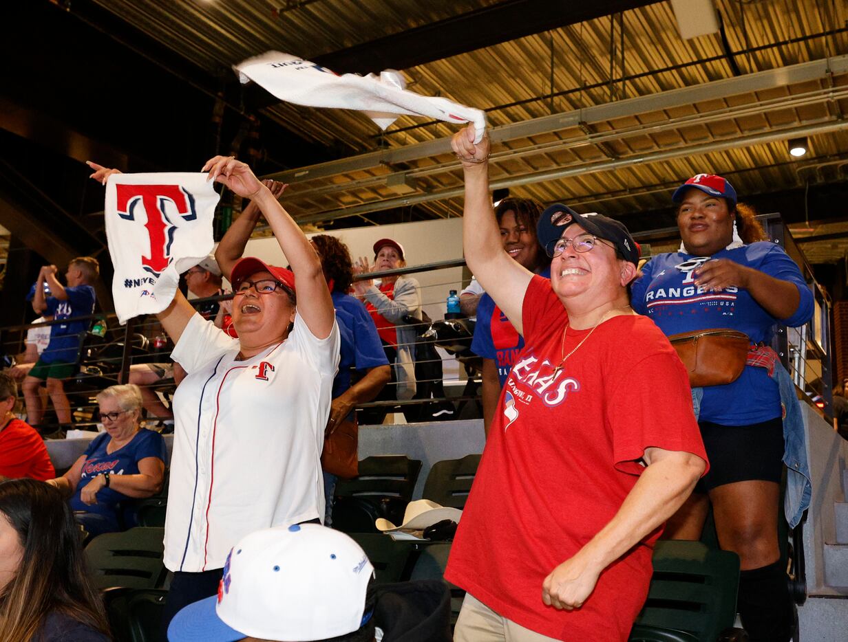 Texas Rangers fans Sonia Williams of Fort Worth, left, and her wife Julie Williams, right,...
