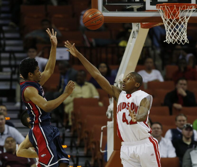 Allen guard Nick Rutherford (24) passes the ball past Converse Judson's Chad Flowers (42)...