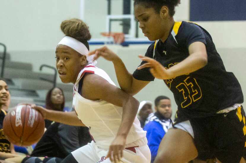 Plano John Paul II senior guard Nevaeh Tot (1) drives the ball past Plano East sophomore...