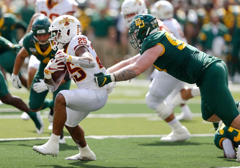 Baylor Bears defensive tackle James Lynch (93) tackles Iowa State Cyclones running back...