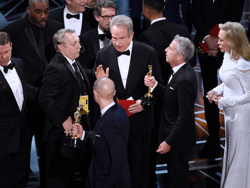 Warren Beatty, center, discusses the results of the award for best picture with Academy of...