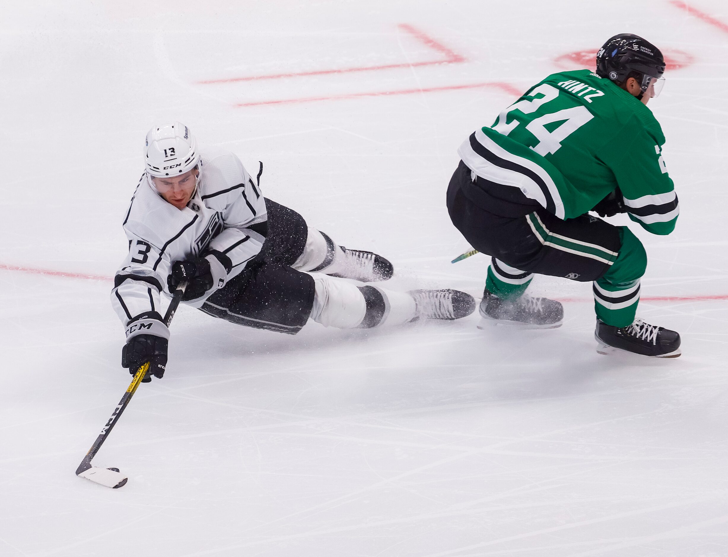 Los Angeles Kings center Gabriel Vilardi (13) falls while guiding the puck during the third...