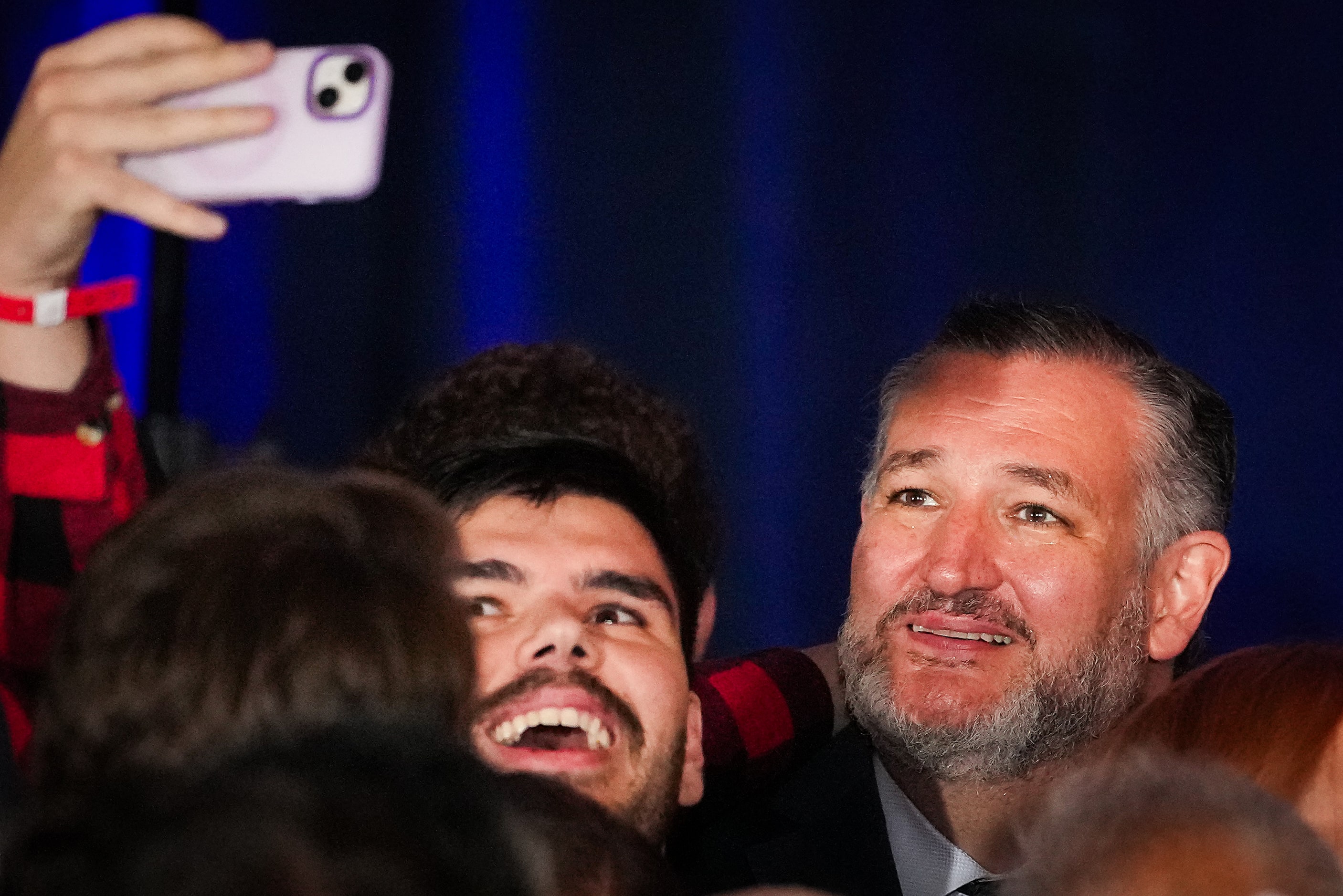 Sen. Ted Cruz, R-Texas, poses for a selfie with a supporter during an election night watch...