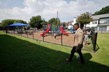 Forest Lane Academy Principal DeMarcus Goree-Watkins walks by a playground at the academy,...