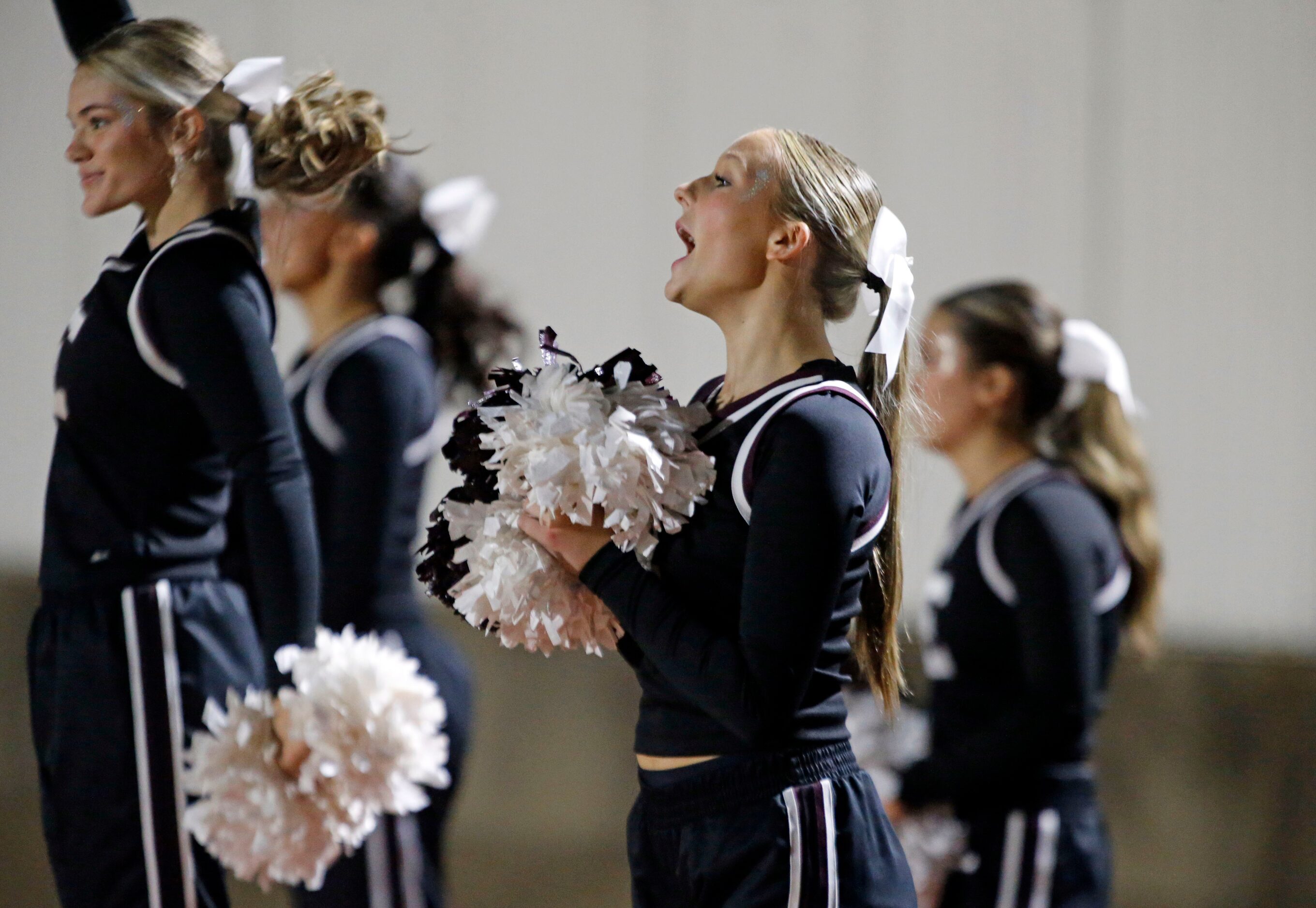 Ennis High cheerleaders yell during first half action in a high school football playoff game...