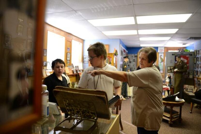 
Docent Deloris Ballard shares Royse City history to Tanner Schot, 11, (left) and Nick...