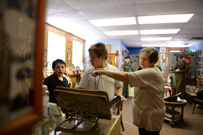 
Docent Deloris Ballard shares Royse City history to Tanner Schot, 11, (left) and Nick...