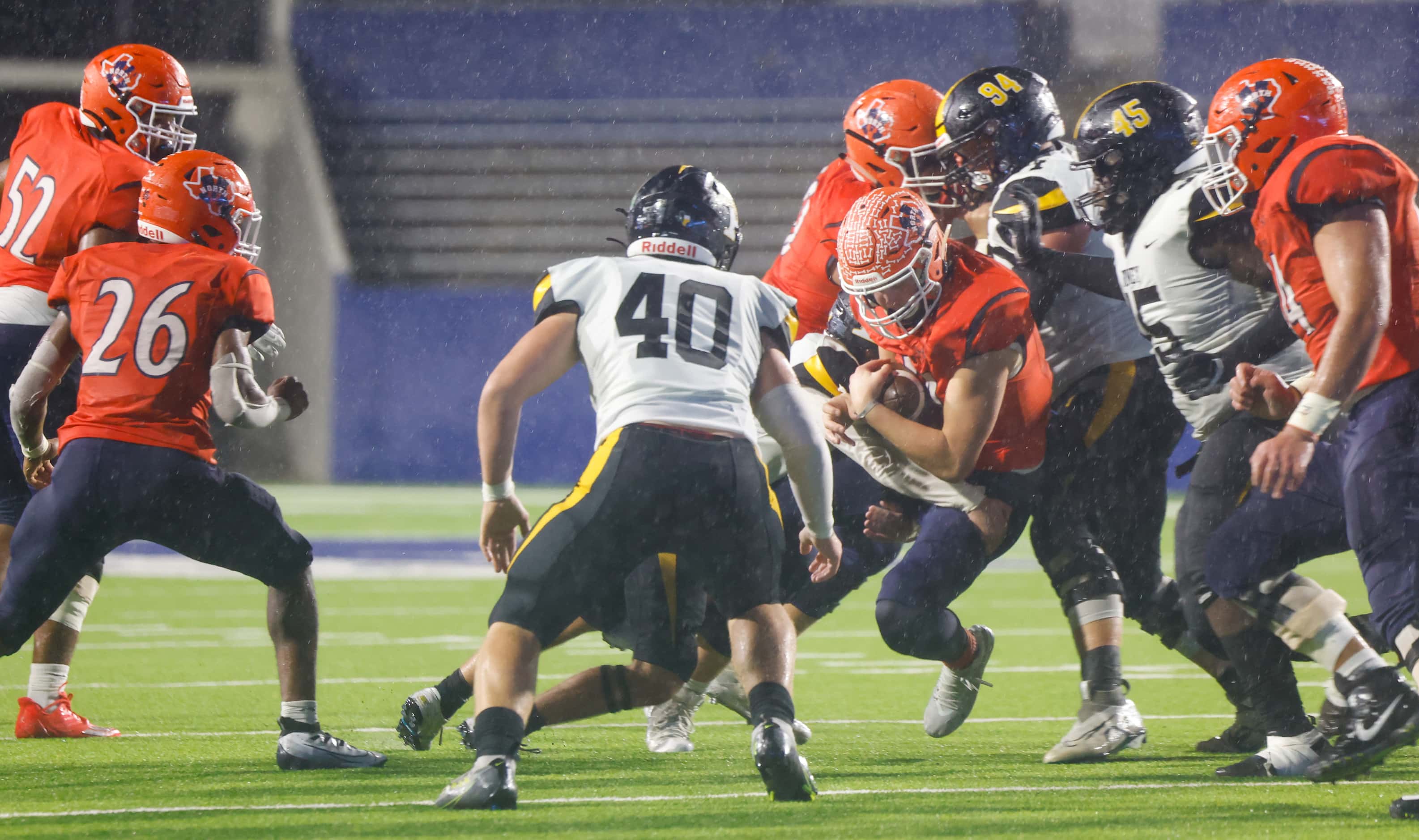 Forney defenders tackles McKinney North quarterback Colin Hitchcock (14) in the second...
