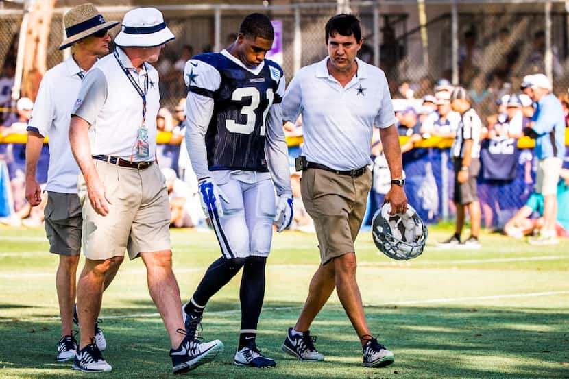 Dallas Cowboys cornerback Byron Jones (31) leaves the field with an injury at training camp...