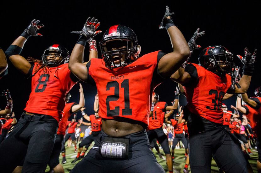 Euless Trinity running back Courage Keihn (21) celebrates a 21-20 win over Southlake Carroll...