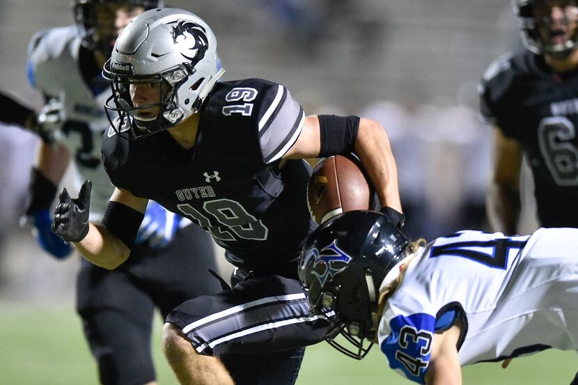 Guyer wide receiver Seth Meador (19) catches a pass and is tackled by Nelson's Nick Kellogg...