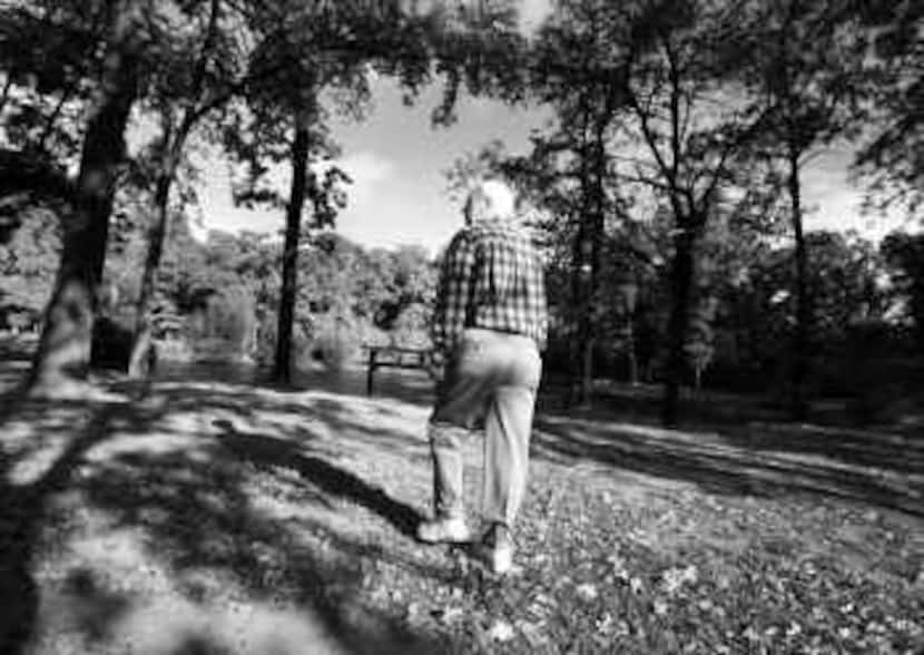 Lee Sneller, who is in the early stages of Alzheimer's disease, takes a daily walk in his...
